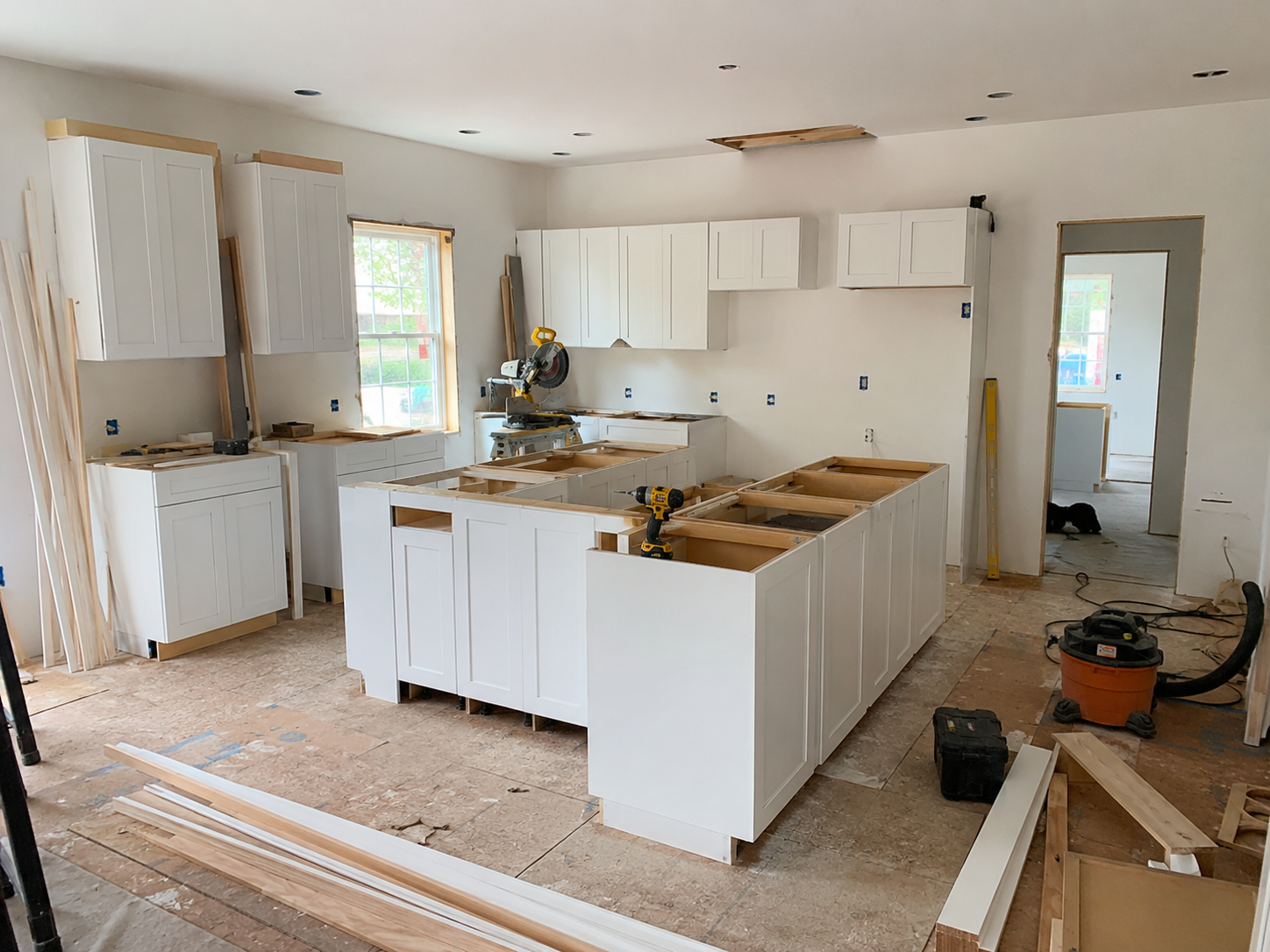 Contractor cabinet package with multiple white shaker cabinets on a jobsite