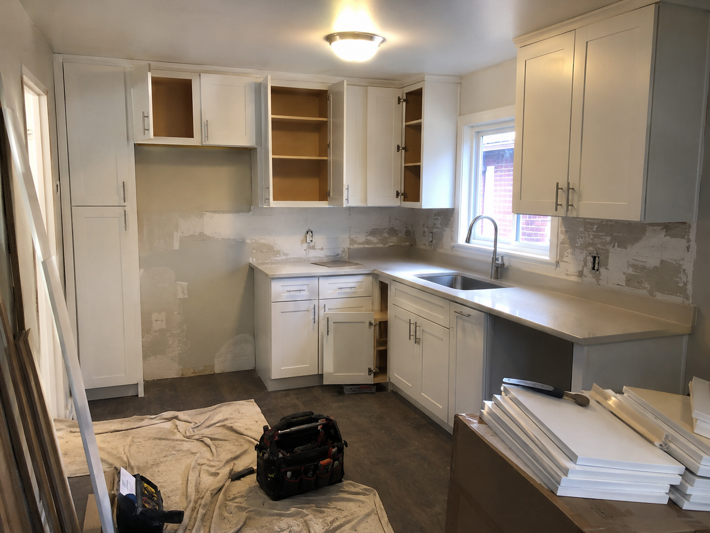 Rental property cabinet upgrade with white shaker cabinets during renovation